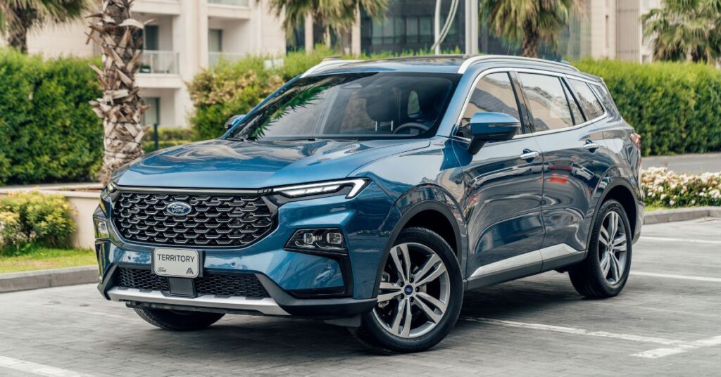 Blue Ford Territory SUV parked in a residential area, showcasing its modern grille, LED headlights, alloy wheels, and spacious design.