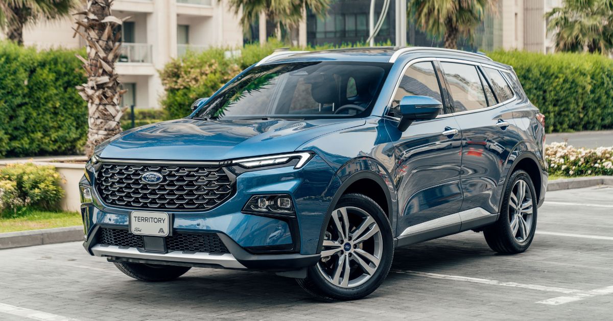 Blue Ford Territory SUV parked in a residential area, showcasing its modern grille, LED headlights, alloy wheels, and spacious design.