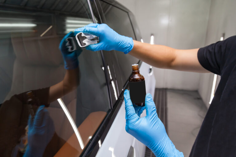 The process of applying a nano-ceramic coating for hydrophobic effect on the car's windows.