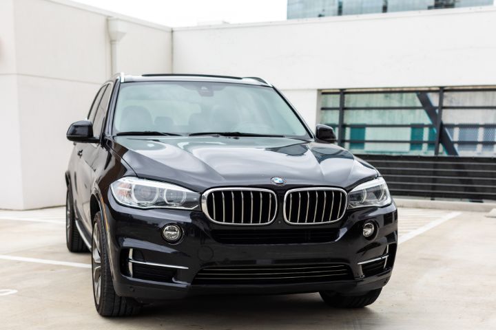 Front view of a black BMW X5 SUV after new windscreen installation