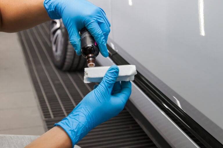 The process of applying and dripping a nano-ceramic coating on the sponge by a male worker.