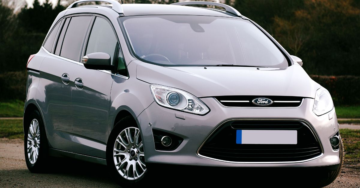 Silver Ford C-Max MPV parked outdoors, featuring a modern front grille, alloy wheels, and spacious family-friendly design.